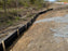 Black silt fence along a roadside slope
