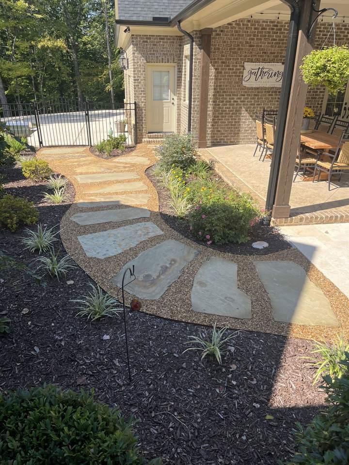 Curved flagstone garden path set in Gravel-Lok stabilized pea gravel beside a covered patio