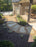 Curved flagstone garden path set in Gravel-Lok stabilized pea gravel beside a covered patio