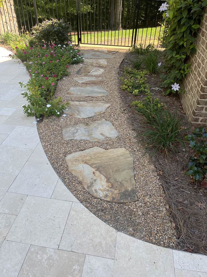 Flagstone stepping stones in Gravel-Lok bonded gravel along a fenced side yard walkway