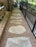 Natural flagstone path in Gravel-Lok stabilized pea gravel curving beside a travertine pool deck
