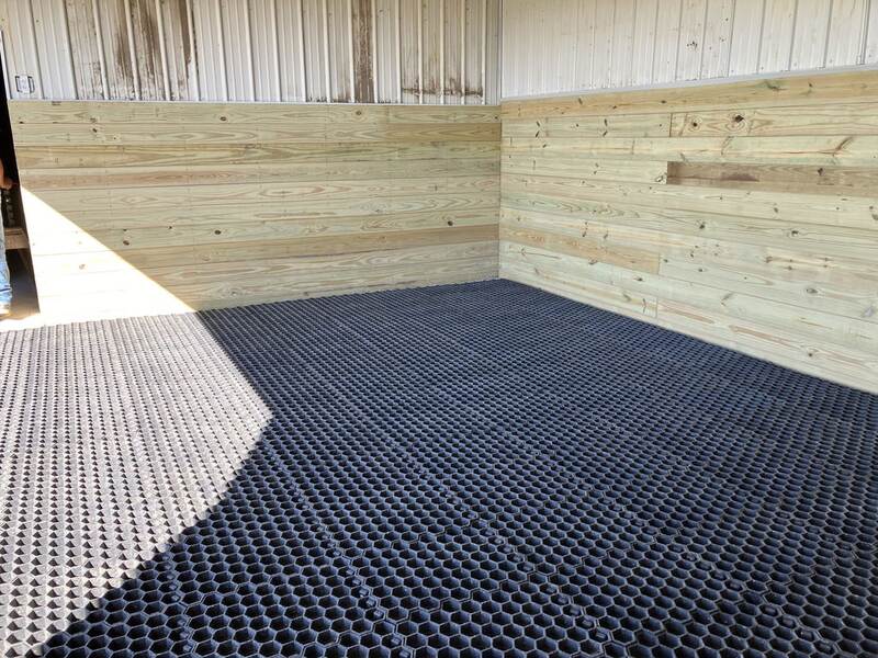 Honeycomb paddock slab ground grid installed in a barn stall
