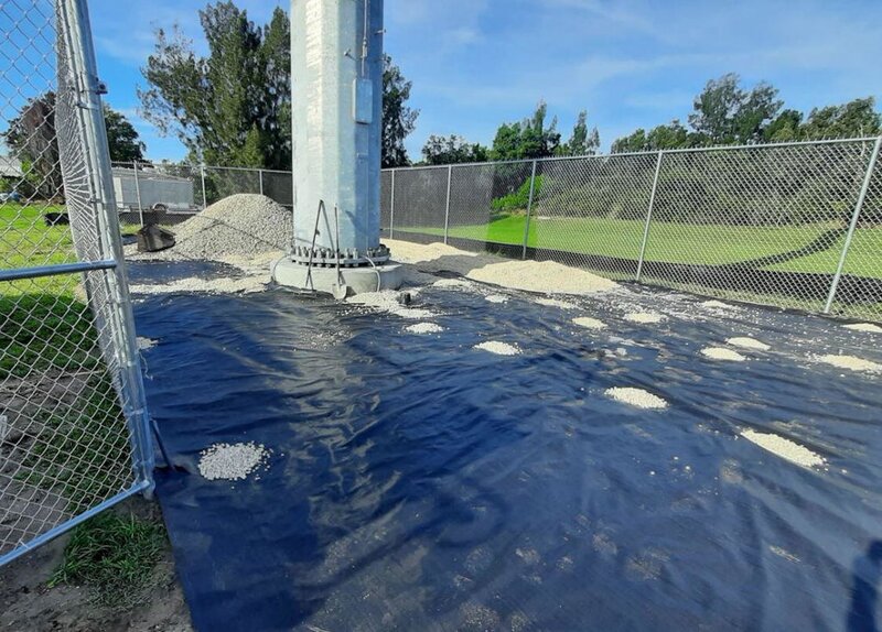 Mirafi 500X woven geotextile separating soil from gravel around a utility pole
