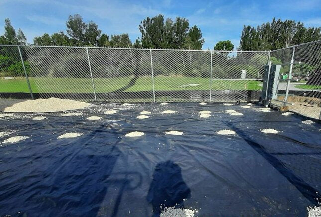 Mirafi 500X woven geotextile installed in a fenced compound before gravel
