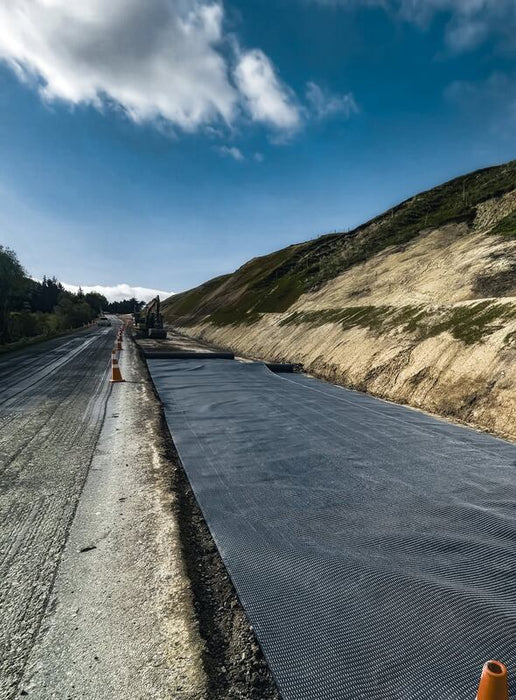 Mirafi H2Ri woven geotextile rolled out for road stabilization
