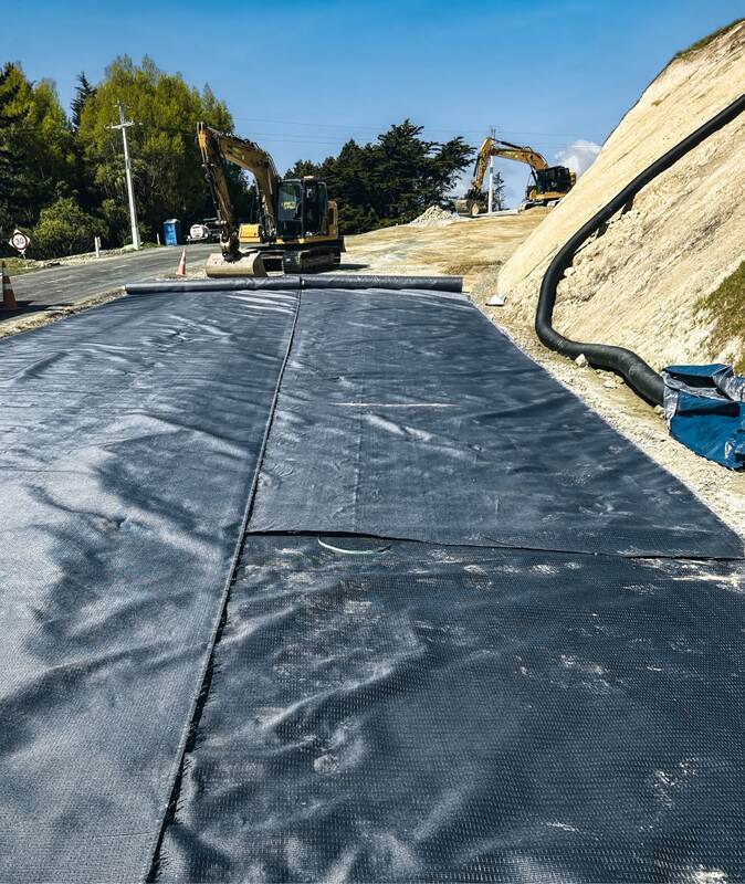 Mirafi H2Ri woven geotextile installed on a roadway with edge drain
