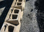 Solmax Miragrid XT geogrid laid over gravel behind retaining wall blocks
