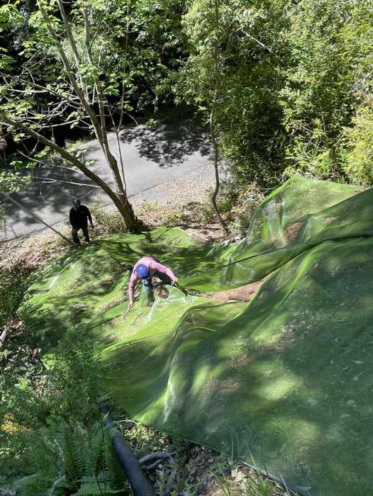 Installing Solmax Miramesh over a slope for erosion control
