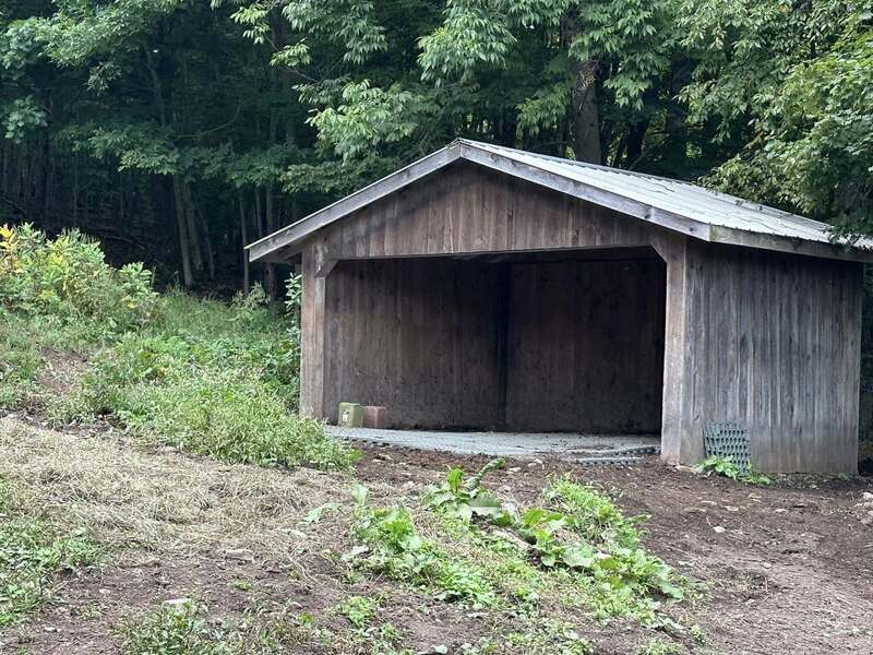 Mud control grid flooring in a horse run-in shed
