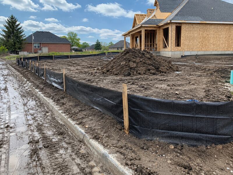 Silt fence installed around a construction site perimeter
