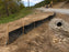 Silt fence and culvert at a roadwork site
