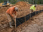 Black silt fence installation at a construction site
