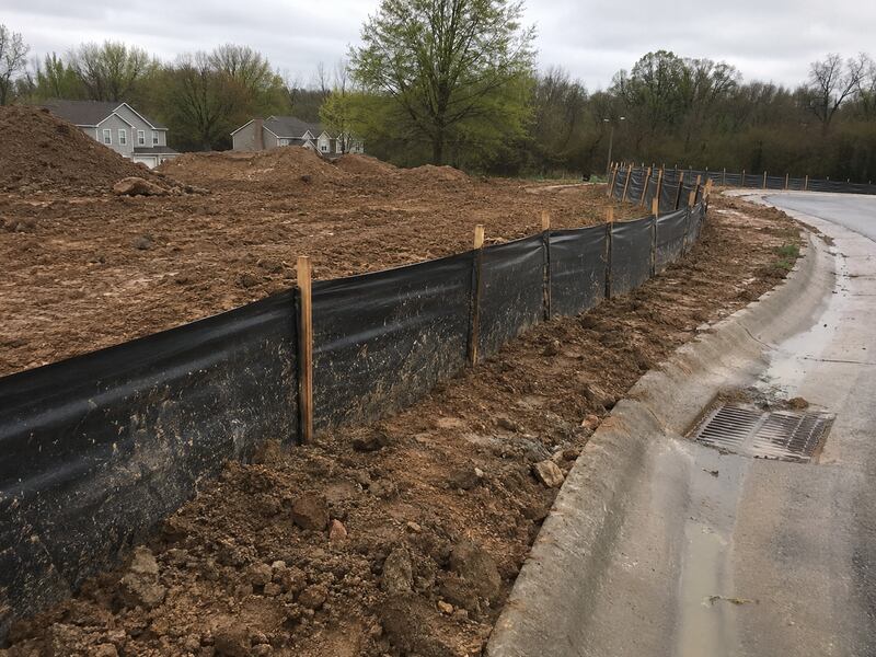 Silt fence and mud along a curb for sediment control
