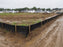 Silt fence at a muddy residential construction site with homes
