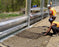 Workers installing Solmax Miragrid XT geogrid at a jobsite
