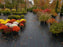 Woven landscape fabric under potted plants at an autumn nursery
