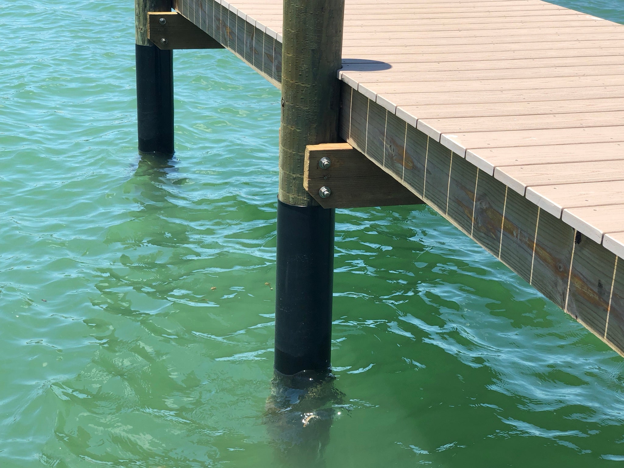 Dock post wrapped in plastic sheeting (dock piling wrap)