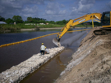 Shore front backhoe construction using a water turbidity curtain