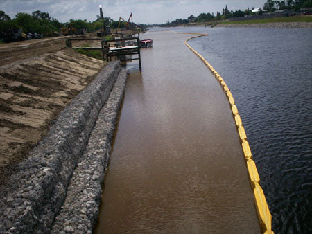 Turbidity curtain containing shoreline sediment from entering a river