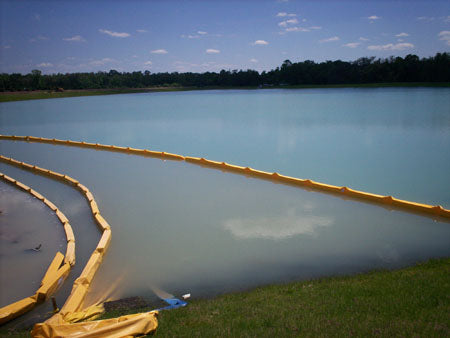 Multiple turbidity curtains floating in a lake