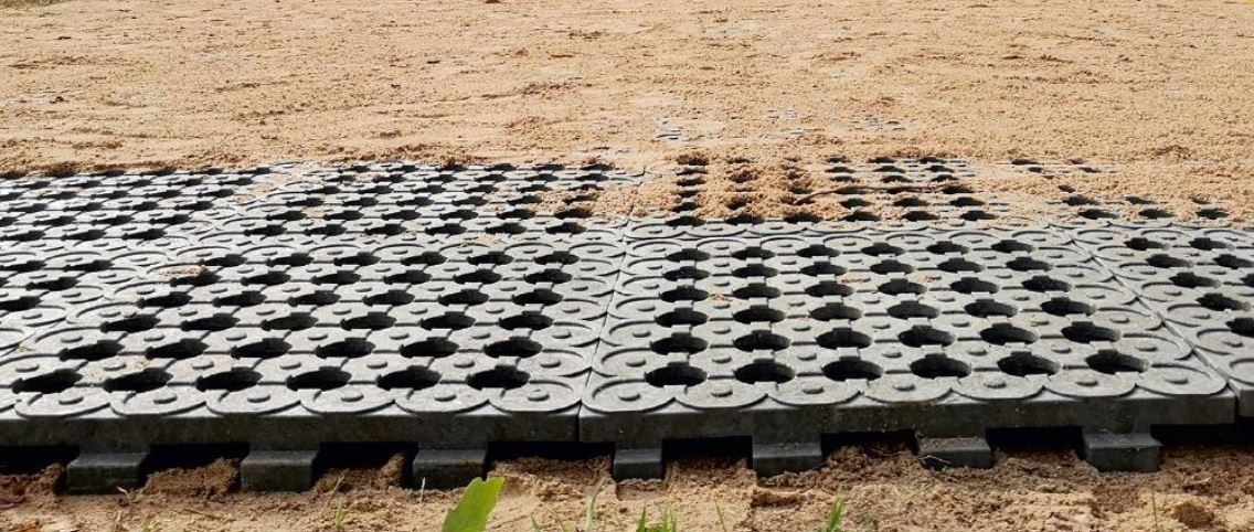 Sand over black plastic paddock grids