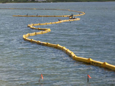 Yellow turbidity curtain floating in water