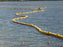 Yellow Turbidity curtain barrier in water